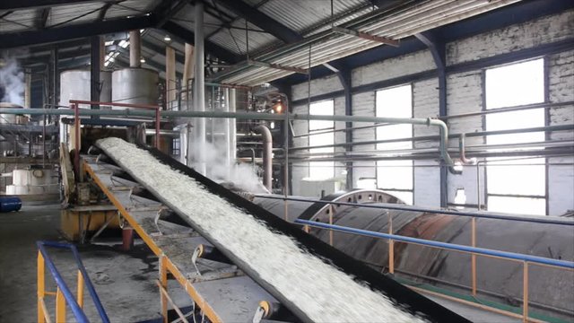 Man working in a factory, controlling of devices in the sugar factory