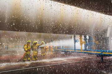 Firefighters training, foreground is drop of water springer, Selective focus