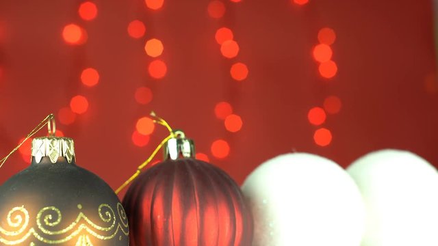 Red and gold baubles with snowballs shot in front of a red curtain with Christmas lights, endless looping, simply add your text or photo gallery on top of it