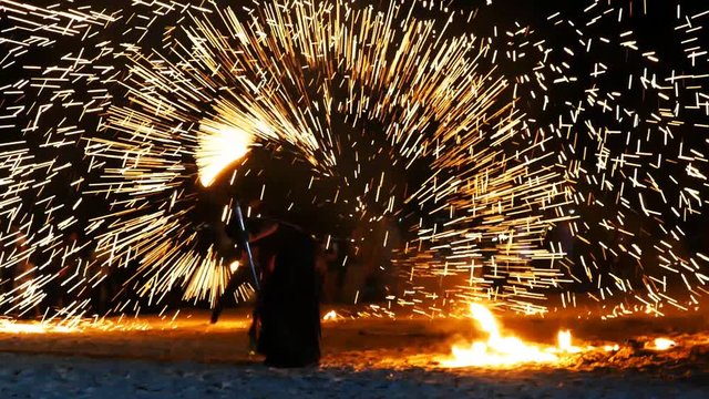 Traditional evening fire dance on the beach.Unrecognizable person, night time 4k 