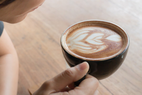Hand on hot coffee latte