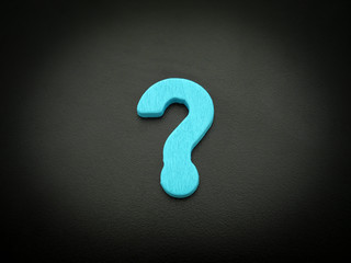 Unique perspective blue question mark sign on black background.
