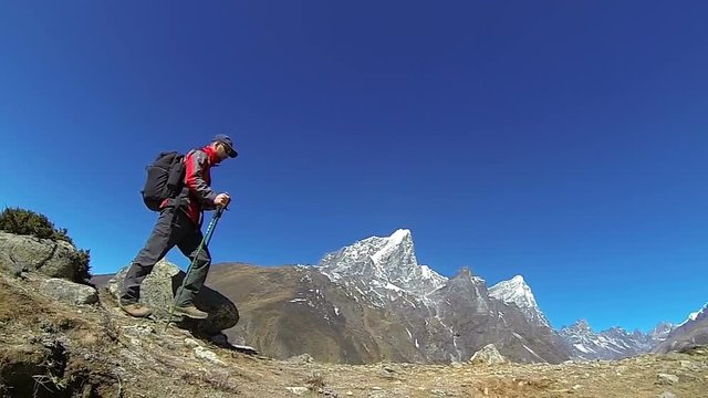 Male mountaineer on the top of world, Mount Everest,Himalayas. Slow motion,high speed camera.
