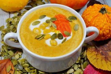 spicy pumpkin soup in a white bowl, selective focus