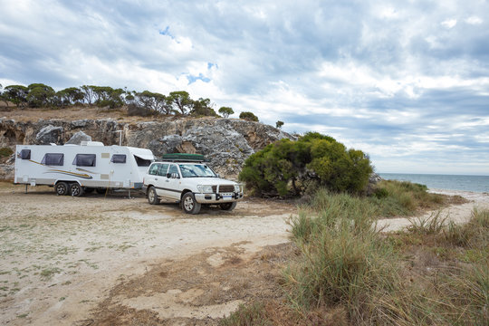 Four wheel drive vehicle and large caravan  at bush camp against