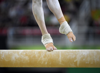 Female gymnast on balance beam during competition
