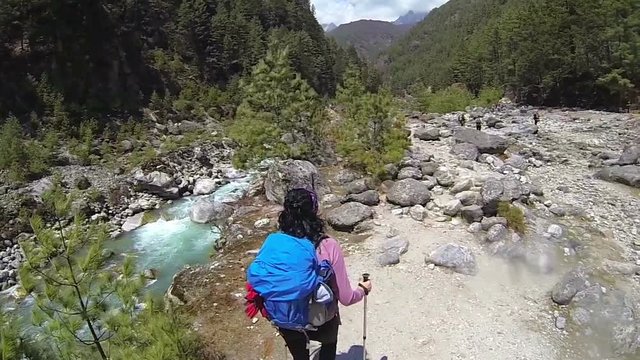 Rear view of woman walking across the Himalayas mountains,slow motion, high speed camera