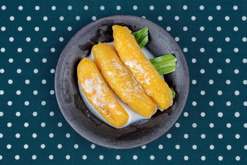 Sweet egg-banana  (Pisang mas) in syrup topped coconut milk