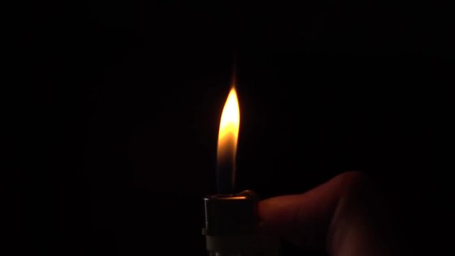 Lighter Slowly Burning on a Black Background, The Bright Lighter Flame in Slow Motion.
