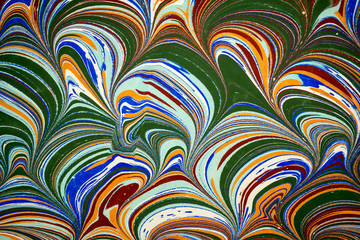 Ebru art. Traditional Turkish Ebru technique. Painting on water, followed by paper prints. Color paint ebru with waves and tile pattern.