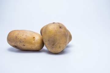 Raw potato on white background isolated.