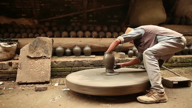 Old potter working in a old traditional way