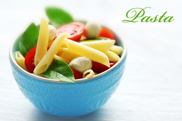 Bowl of delicious pasta, closeup. Italian food concept. Word PASTA on background.