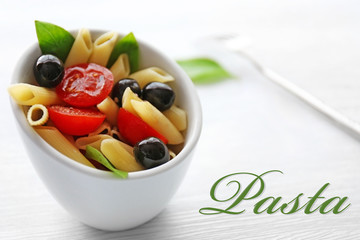 Bowl of delicious pasta, closeup. Italian food concept. Word PASTA on background.