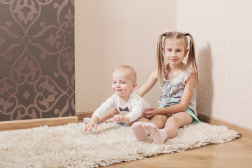 little boy with his sister  at home