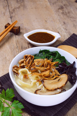 malaysian chinese cuisine pan mee noodle in soup on white bowl.