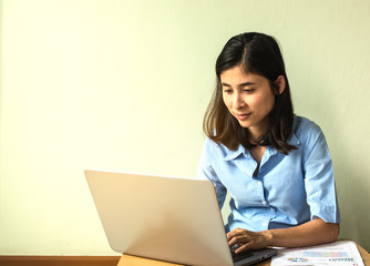 Portrait of a young business woman using laptop and think abou s