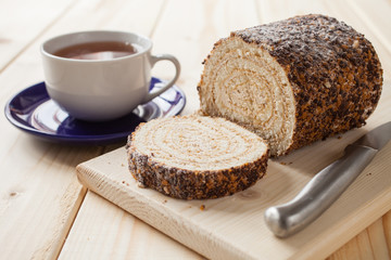 swiss roll and tea on a table, selective focus