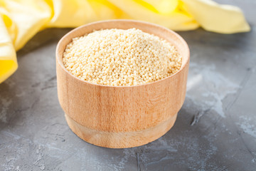 Obraz na płótnie Canvas millet grain in a bowl on a table, выборочынй focus