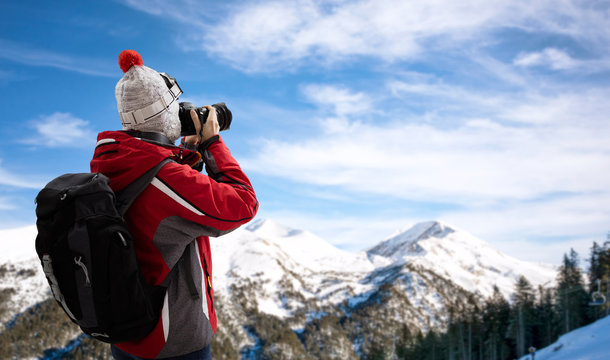 Woman in ski suit takes picture