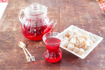 garnet red tea and the Turkish delight on a table, selective focus
