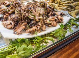 fried baby octopus on display at the market fast snack concept