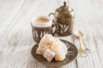 Fototapeta premium coffee and the Turkish delight on a table, selective focus