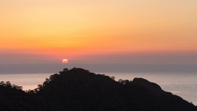 scenic sunrise background sun rising. timelapse of sun rising behing sea and mountains