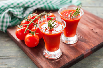 tomato juice and tomatoes on a table, selective focus
