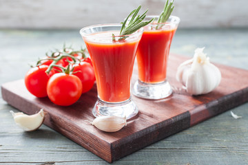 tomato juice and tomatoes on a table, selective focus
