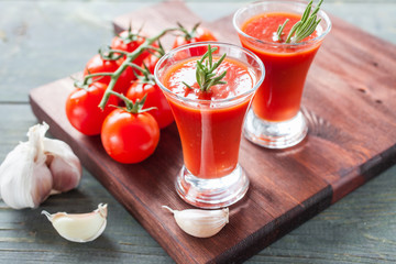 tomato juice and tomatoes on a table, selective focus