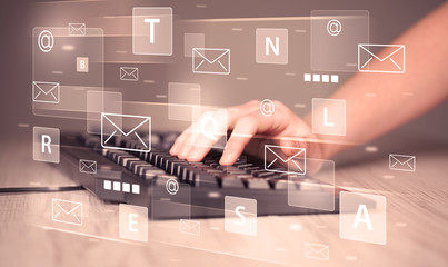 Hand typing on keyboard with digital tech icons