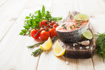 stake of a salmon with a lemon and vegetables on a table, selective focus