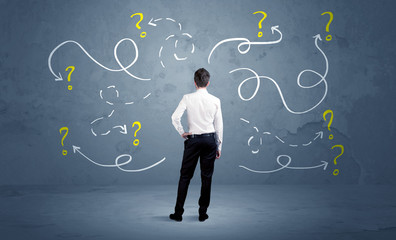 Unsure businessman with question marks