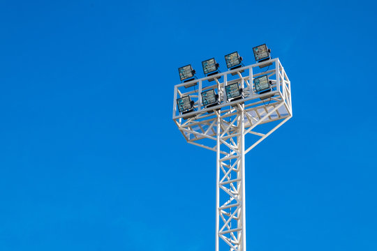 Stadium lights in daylight and blue sky background