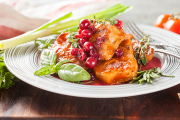 meat with cranberry sauce and vegetables on a table, selective focus