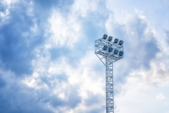 Stadium lights in daylight and blue sky background