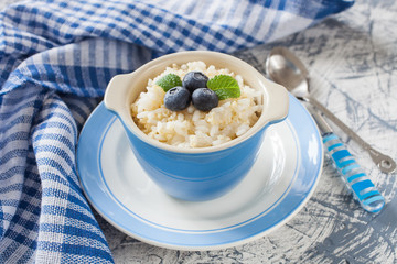 millet rice porridge in a bowl on a table, selective focus
