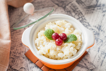 millet rice porridge in a bowl on a table, selective focus
