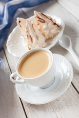 coffee and cakes of meringue on a table, selective focus
