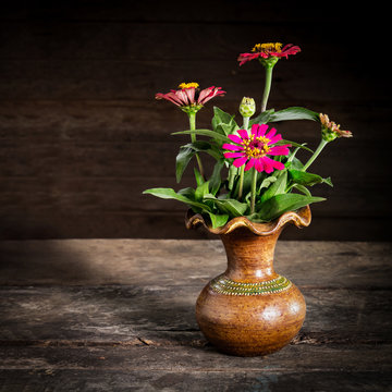 Still Life with a vase flower,earthenware on wooden