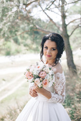 Beautiful bride outdoors in a forest.