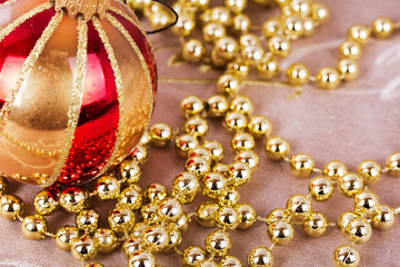 Festive gold Christmas decorations on fabric background