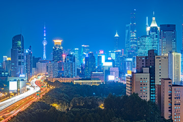 Fototapeta premium blurred traffic light trails on road at night in China.