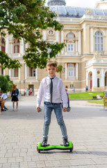 Fototapeta premium Stylish young boy riding a hover board