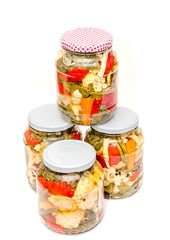 Jar with pickles containing cauliflower, cucumber, red pepper