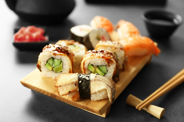 Delicious sushi set on wooden board