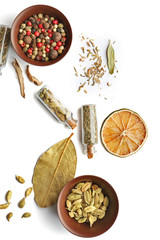 Flat lay of assorted herbs and spices on white background