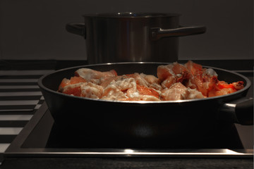 Frying pan with chicken meat