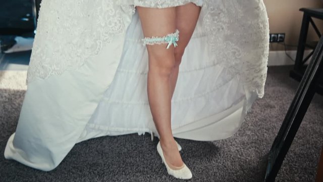beautiful legs of the bride with garter